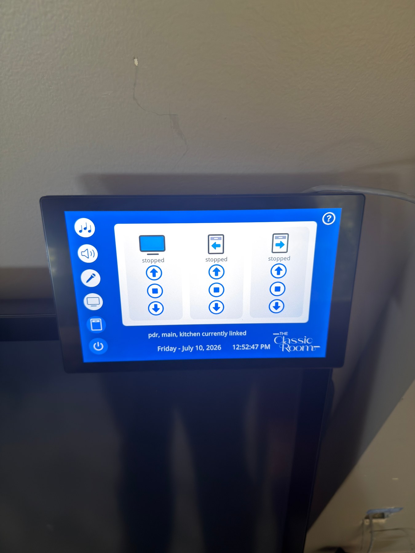 Installed Q-SYS touchscreen showing the Classic Room shade-control page