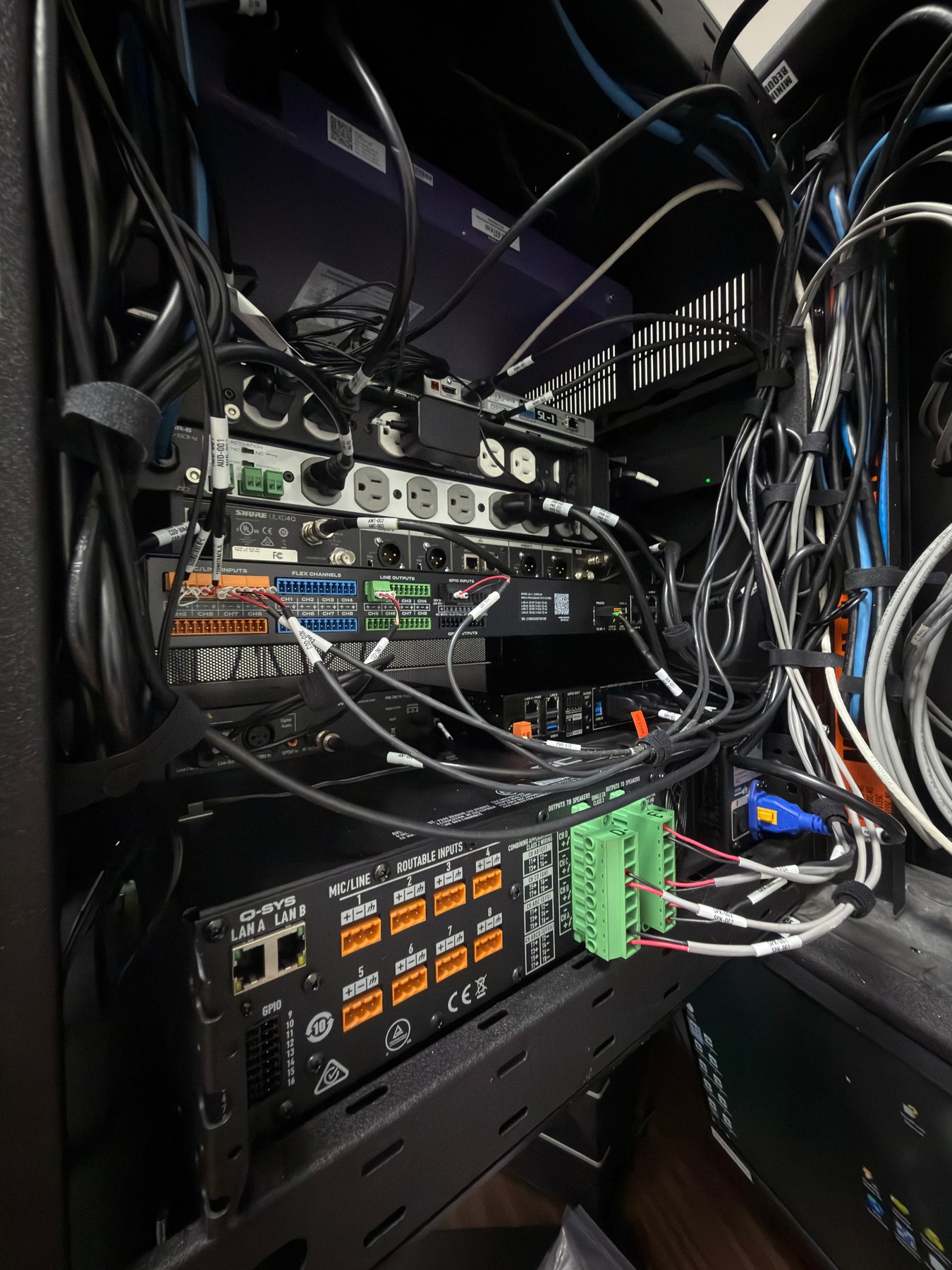 Rear of the Classic Room equipment rack during installation with labeled audio, network, control, and loudspeaker connections